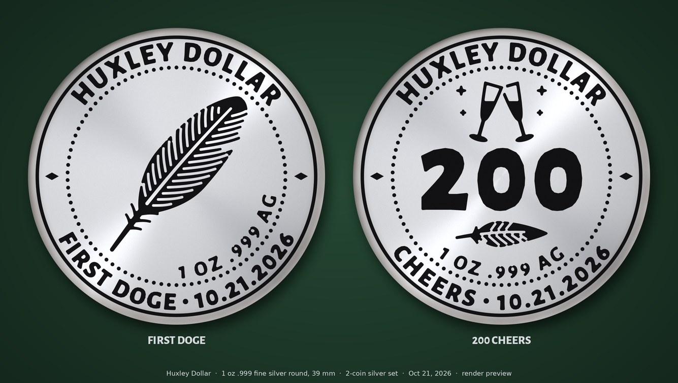 The two silver ceremonial coins side by side: the First DOGE feather coin and the 200 Cheers coin